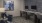 a room with a desk and chairs