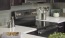 a kitchen with a stove and a potted plant