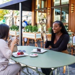 Bustling community with plenty of dining choices two people having a meal and coffee together