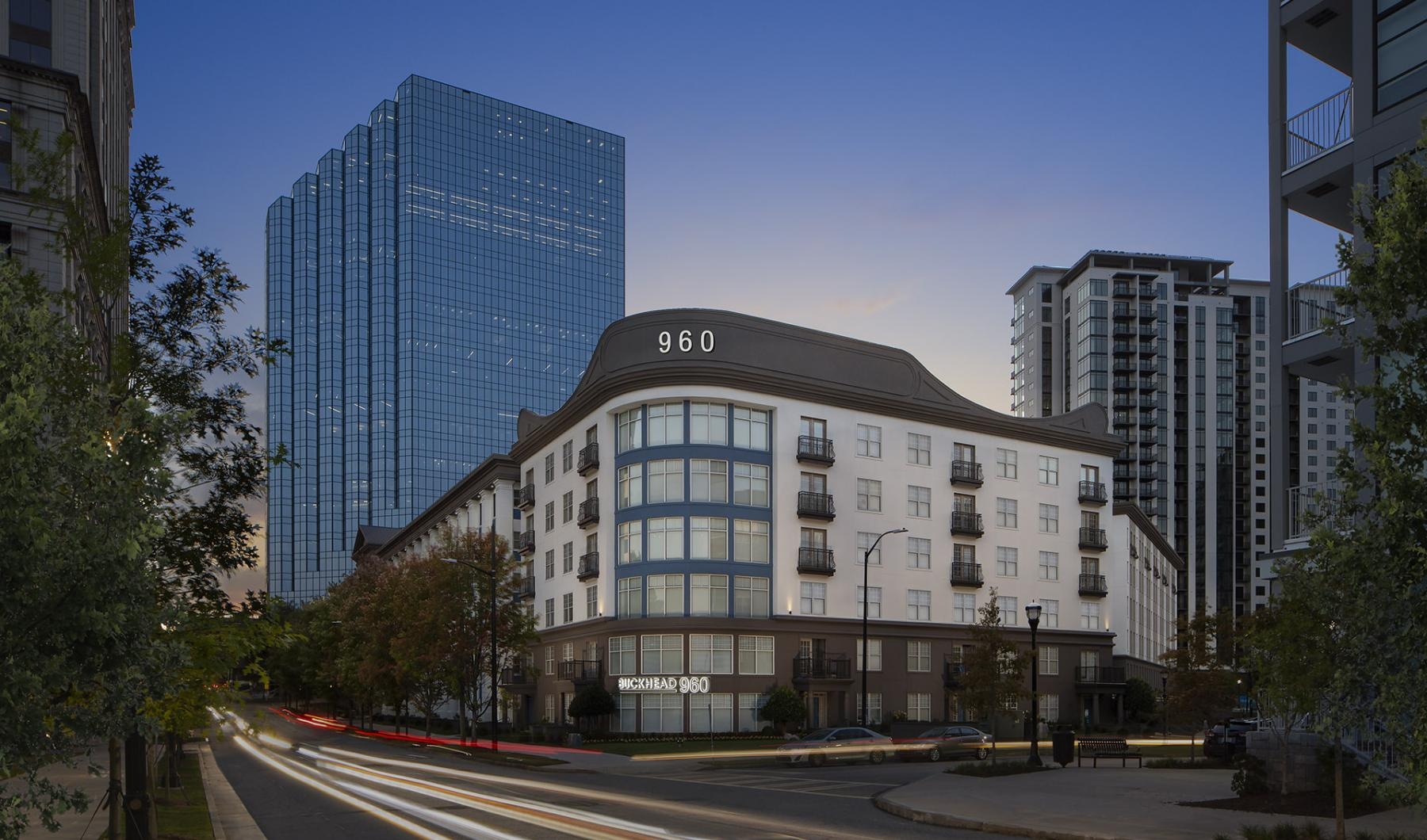 a street with buildings on the side with Moscone Center in the background