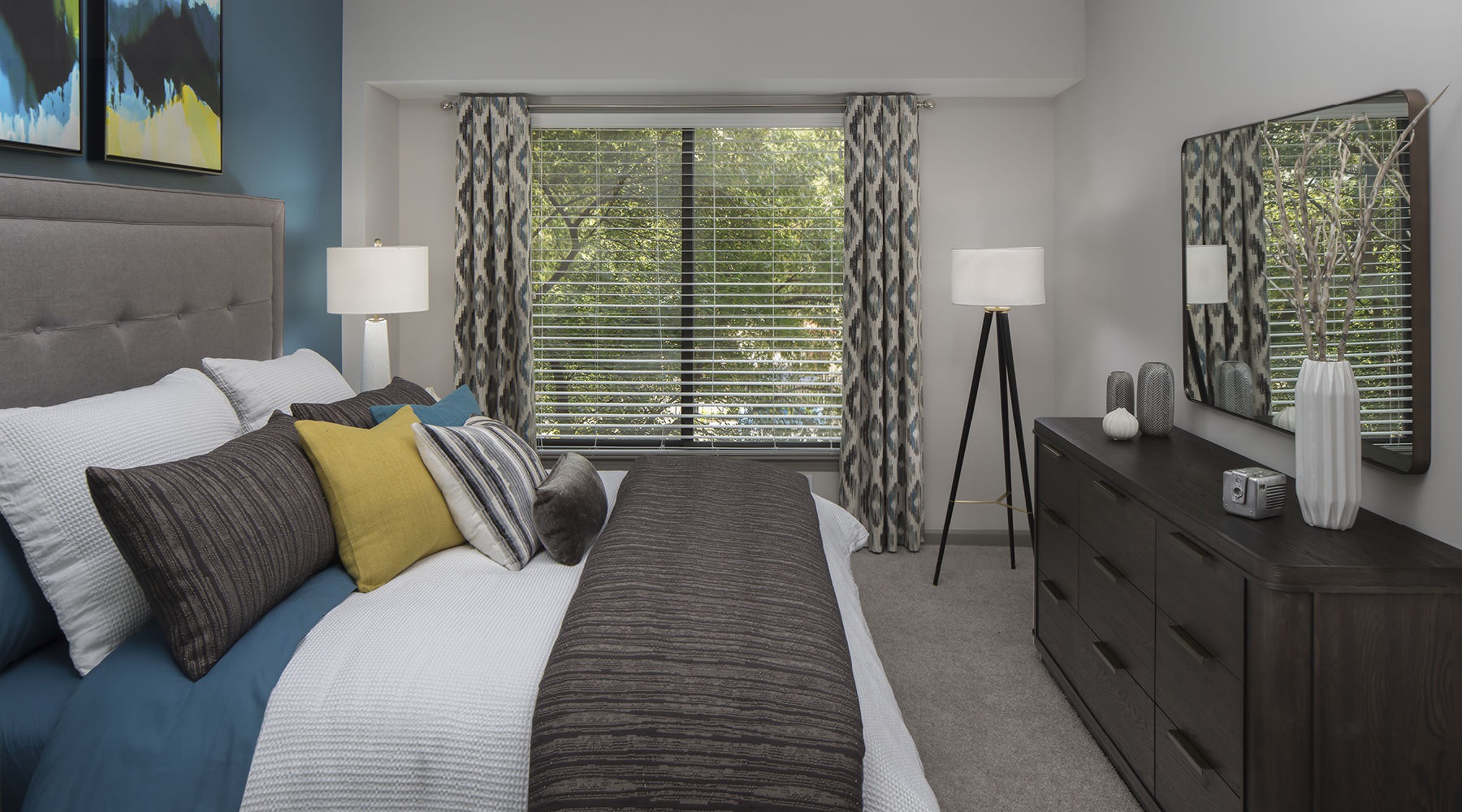 a bedroom with a bed and a dresser