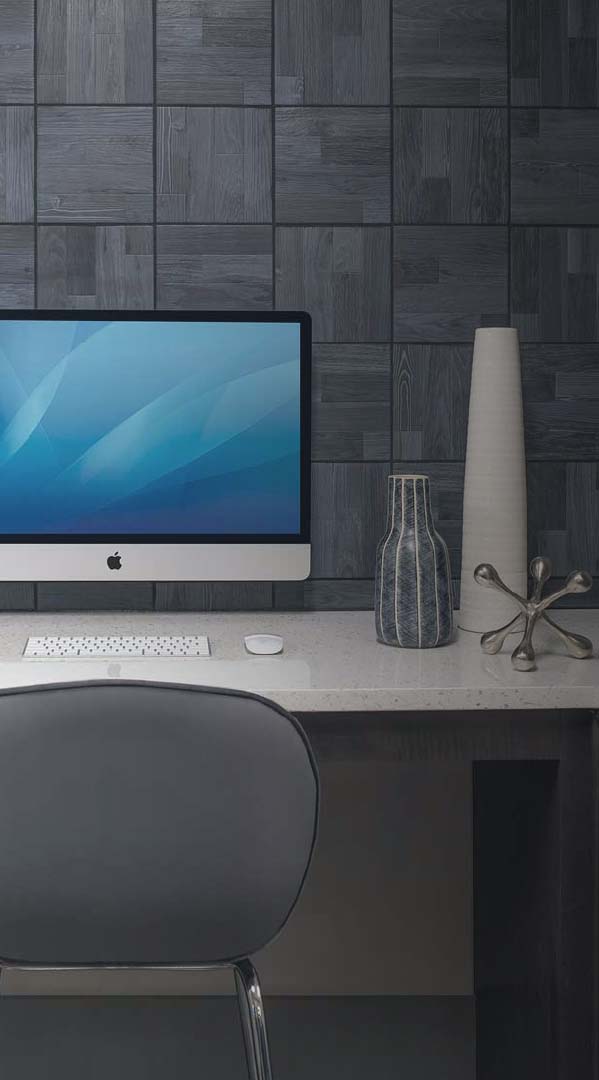 Office room with a desk set up featuring an Apple monitor
